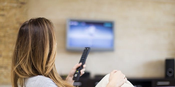 how to connect headphones to TV - Lady watching TV 2